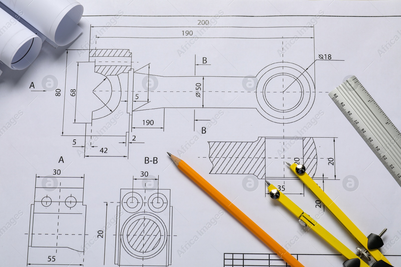 Photo of Different engineering drawings, pencil, ruler and divider on table, flat lay