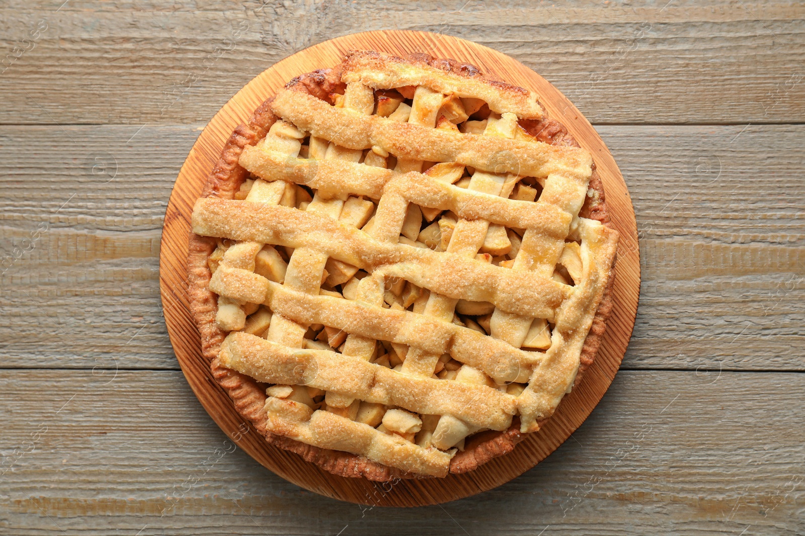 Photo of Tasty homemade apple pie on wooden table, top view