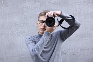 Photo of Professional photographer taking picture with camera outdoors