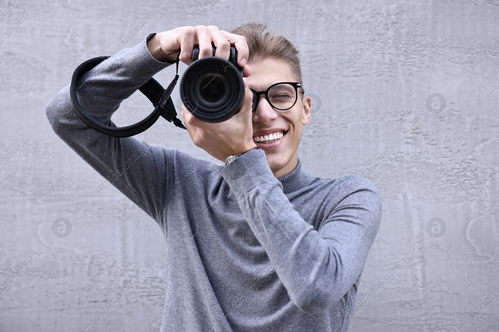 Photo of Professional photographer taking picture with camera outdoors