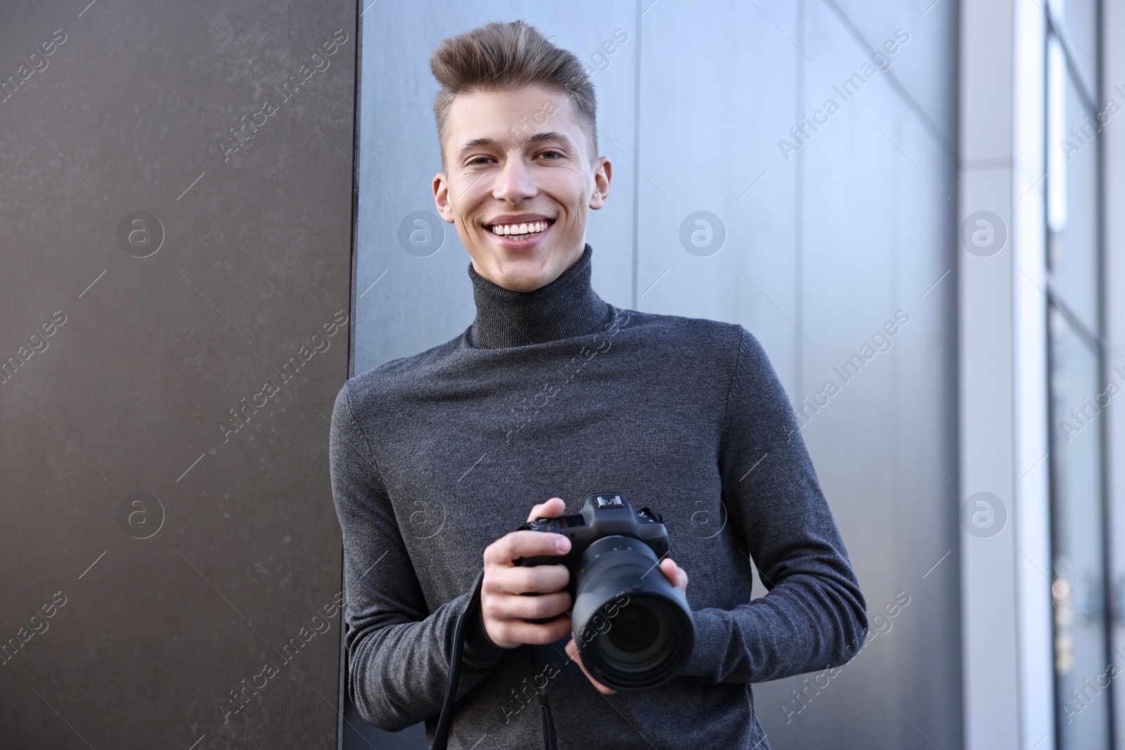 Photo of Professional photographer with camera near building outdoors