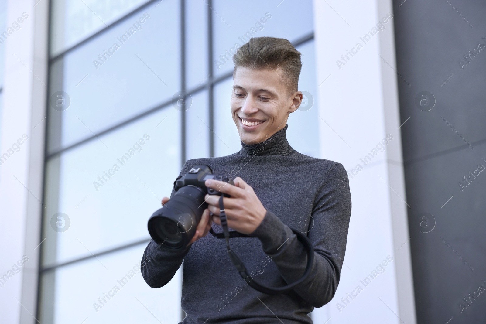 Photo of Professional photographer with camera near building outdoors