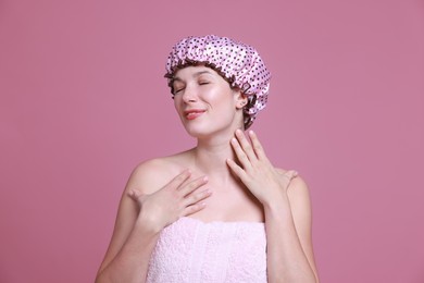 Photo of Woman in shower cap on pink background