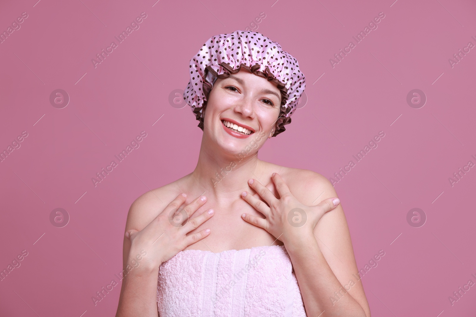 Photo of Woman in shower cap on pink background