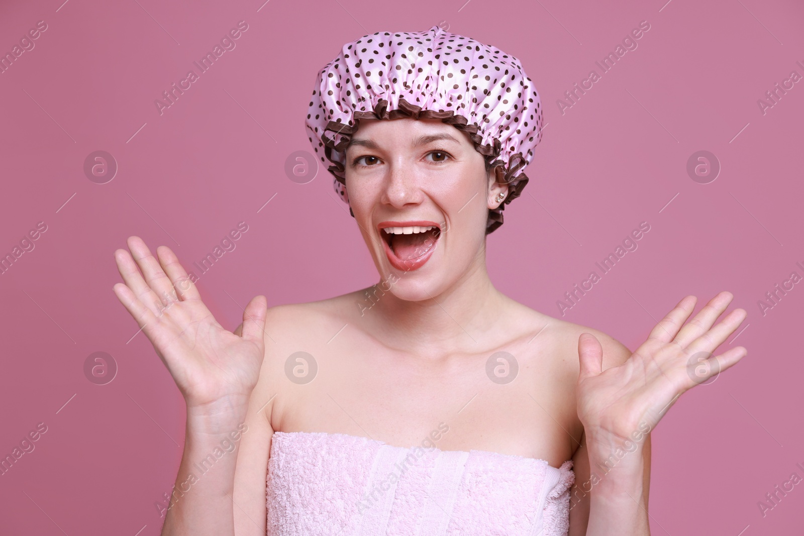 Photo of Woman in shower cap on pink background