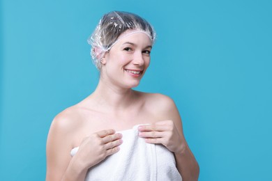 Photo of Woman in shower cap on light blue background