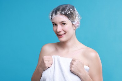 Photo of Woman in shower cap on light blue background