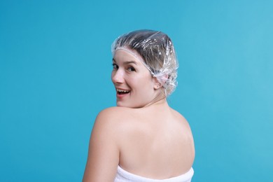 Photo of Woman in shower cap on light blue background