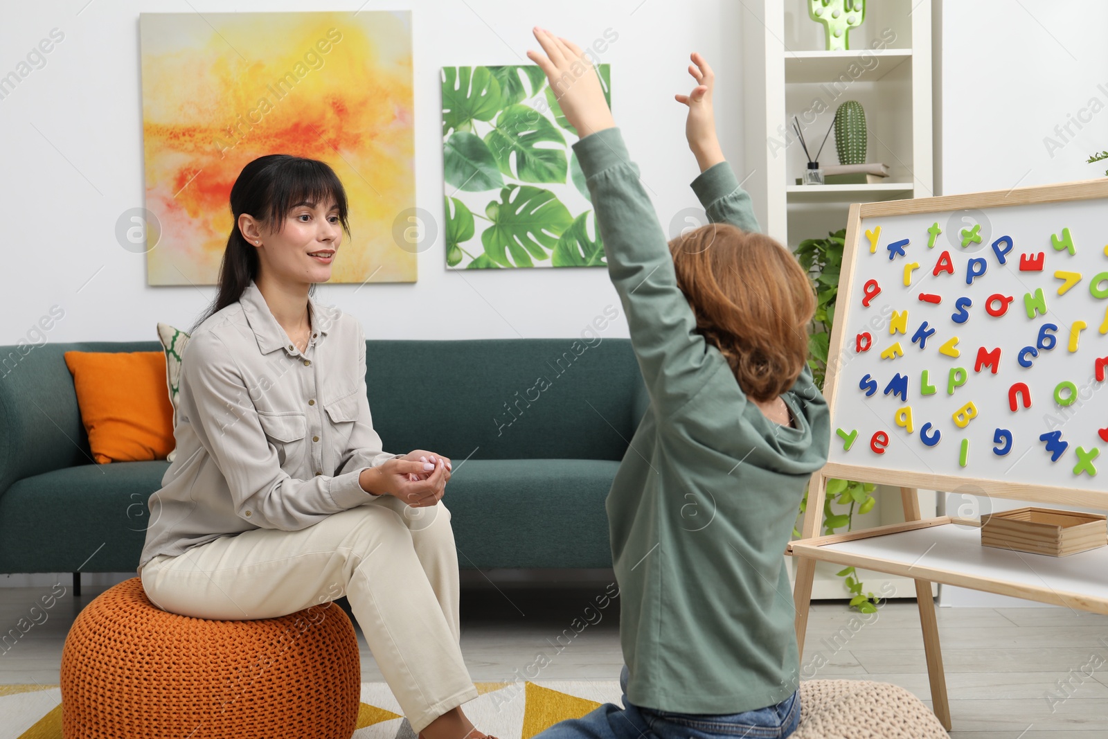 Photo of Psychologist having consultation with little boy in office