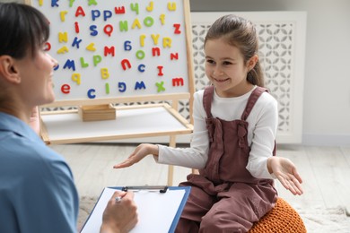 Little girl having consultation with psychologist in office