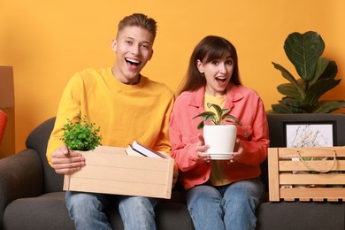 Happy couple with different stuff in new apartment. Housewarming party