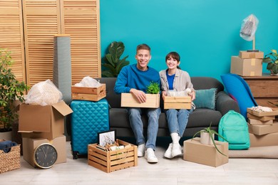 Happy couple with different stuff in new apartment. Housewarming party