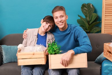 Photo of Happy couple with different stuff in new apartment. Housewarming party