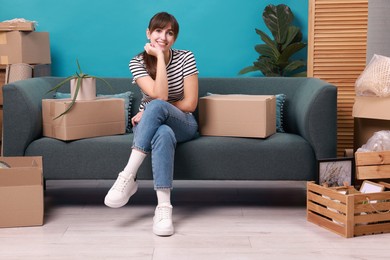 Photo of Happy woman with moving boxes in new apartment. Housewarming party