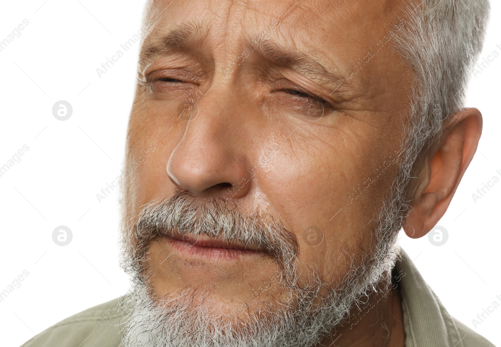 Photo of Sad senior man crying on white background, closeup