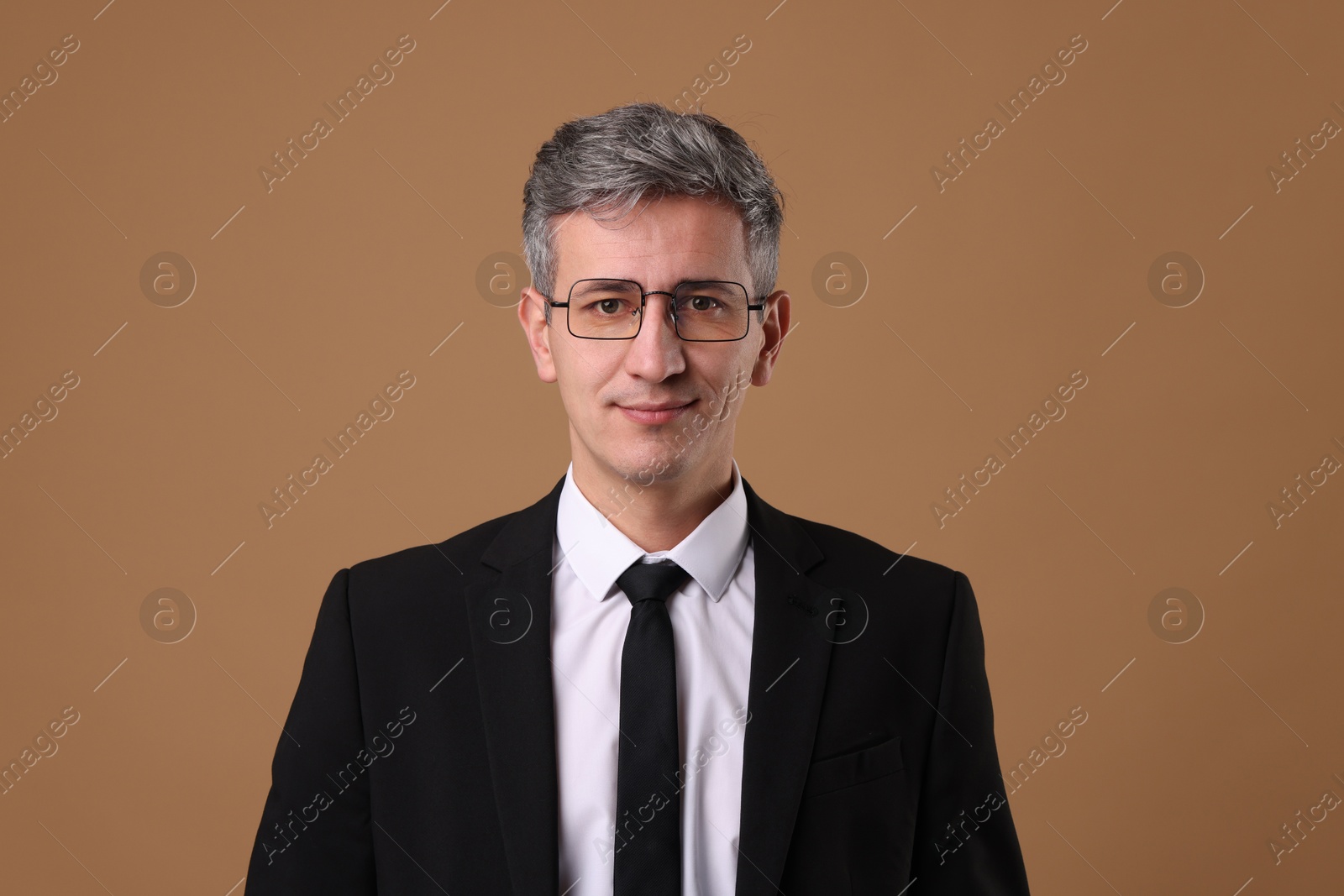 Photo of Portrait of businessman in glasses on brown background