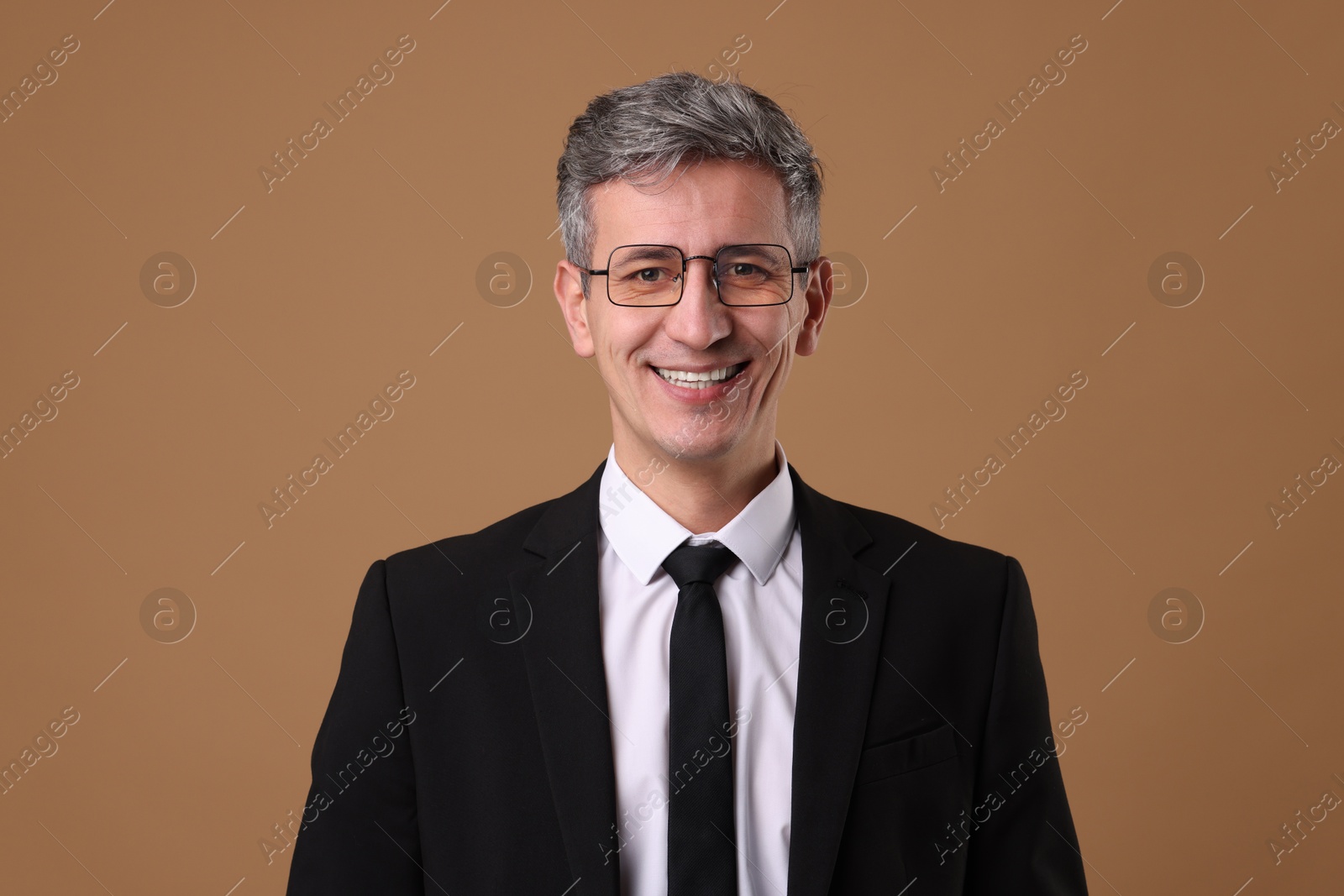 Photo of Portrait of businessman in glasses on brown background