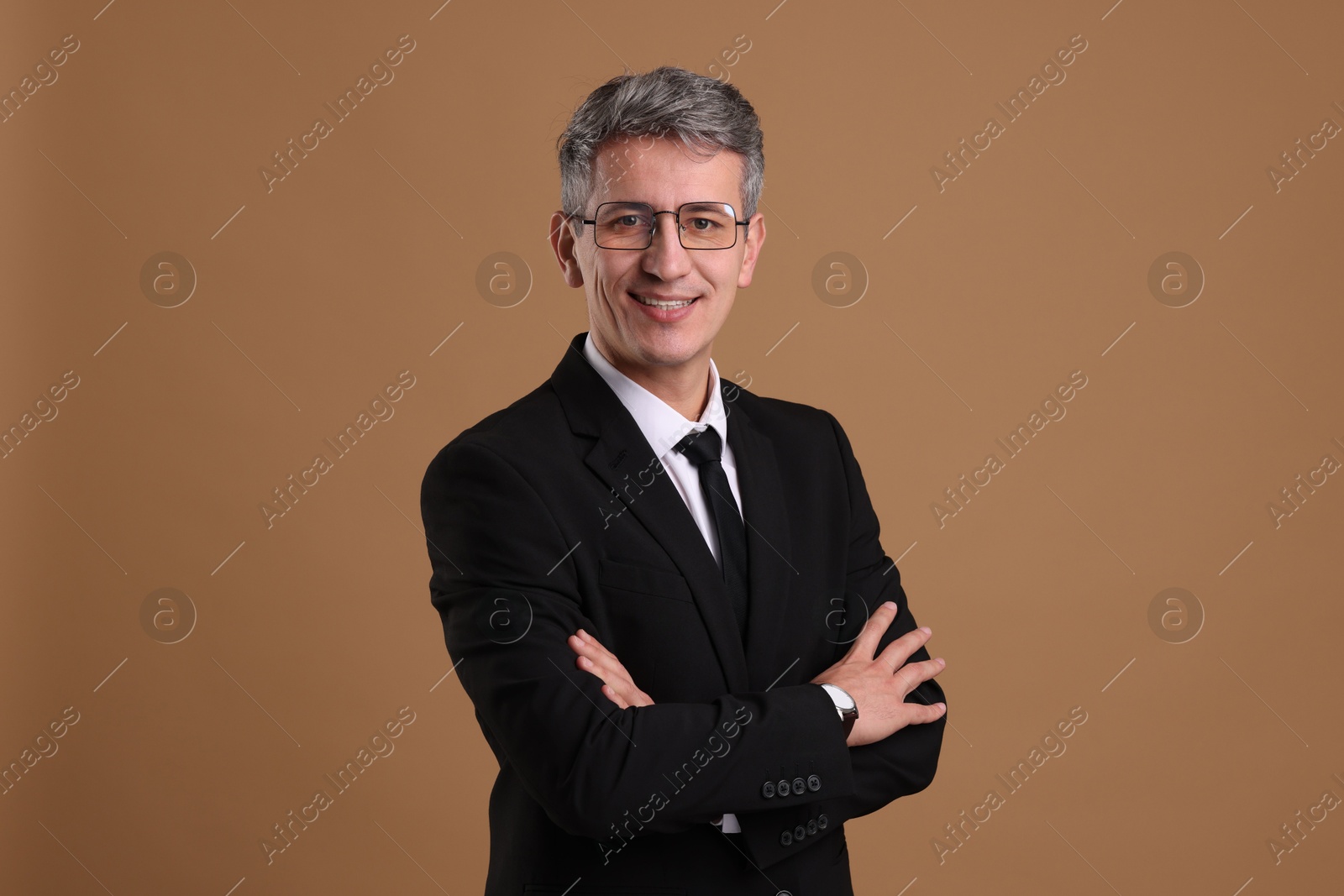 Photo of Portrait of businessman in glasses on brown background