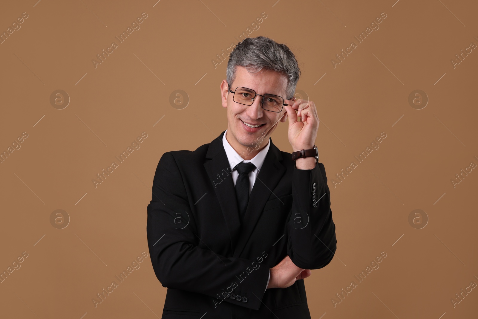 Photo of Portrait of businessman in glasses on brown background