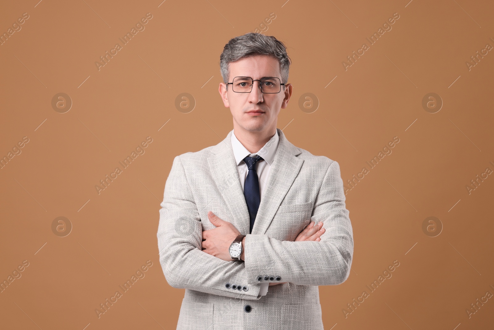 Photo of Portrait of businessman in glasses on brown background