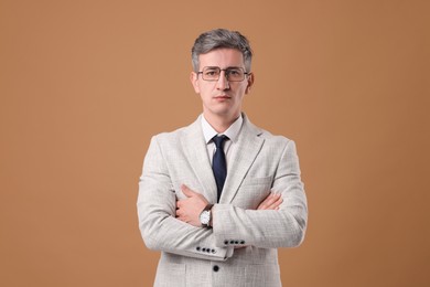 Photo of Portrait of businessman in glasses on brown background