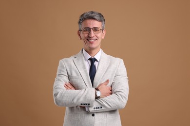 Photo of Portrait of businessman in glasses on brown background