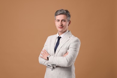 Photo of Portrait of businessman in jacket on brown background