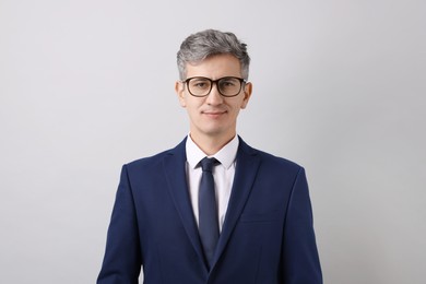 Photo of Portrait of businessman in glasses on light grey background