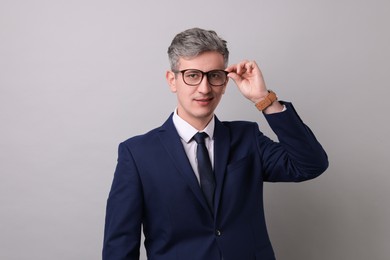 Photo of Portrait of businessman in glasses on light grey background