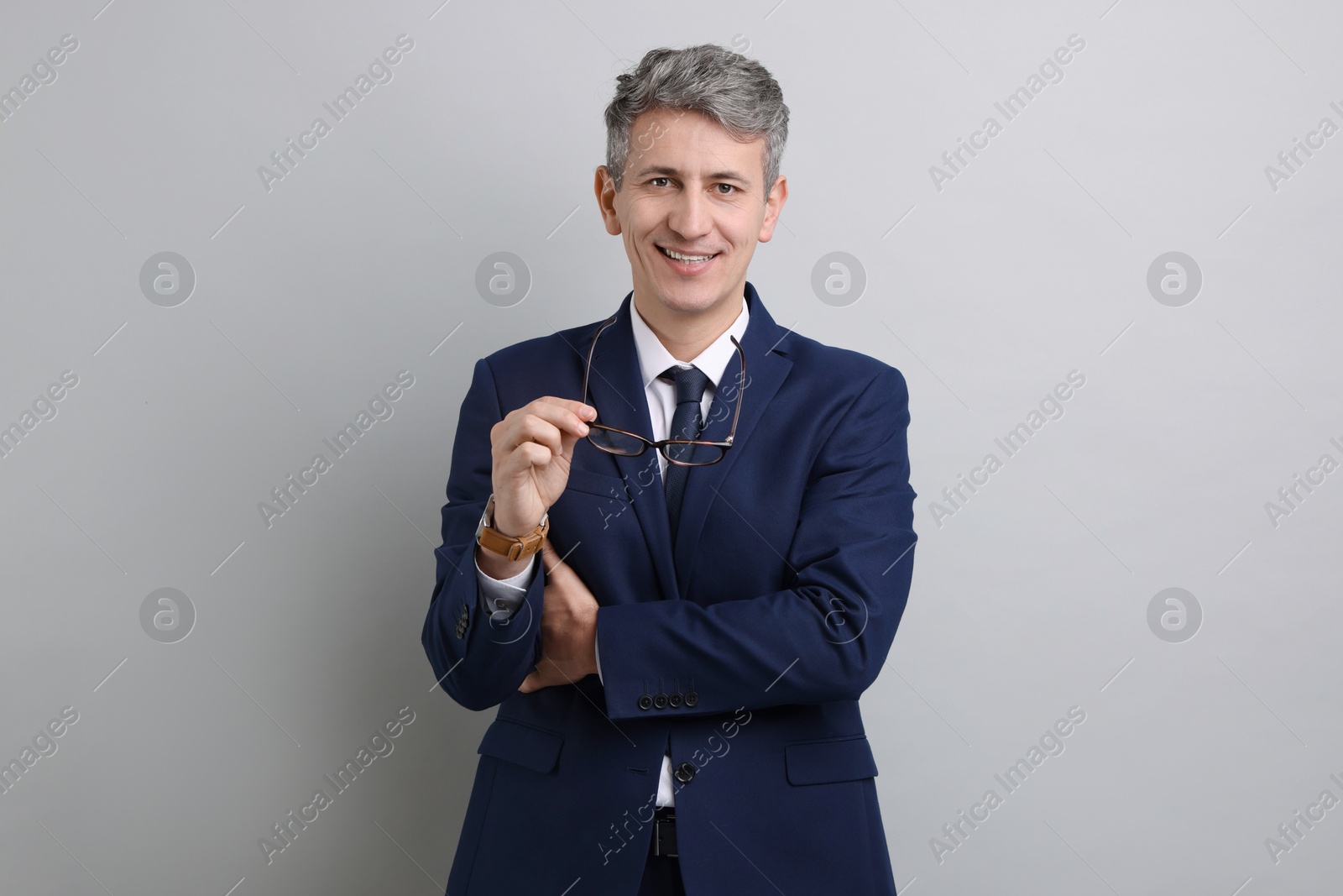 Photo of Portrait of businessman with glasses on light grey background