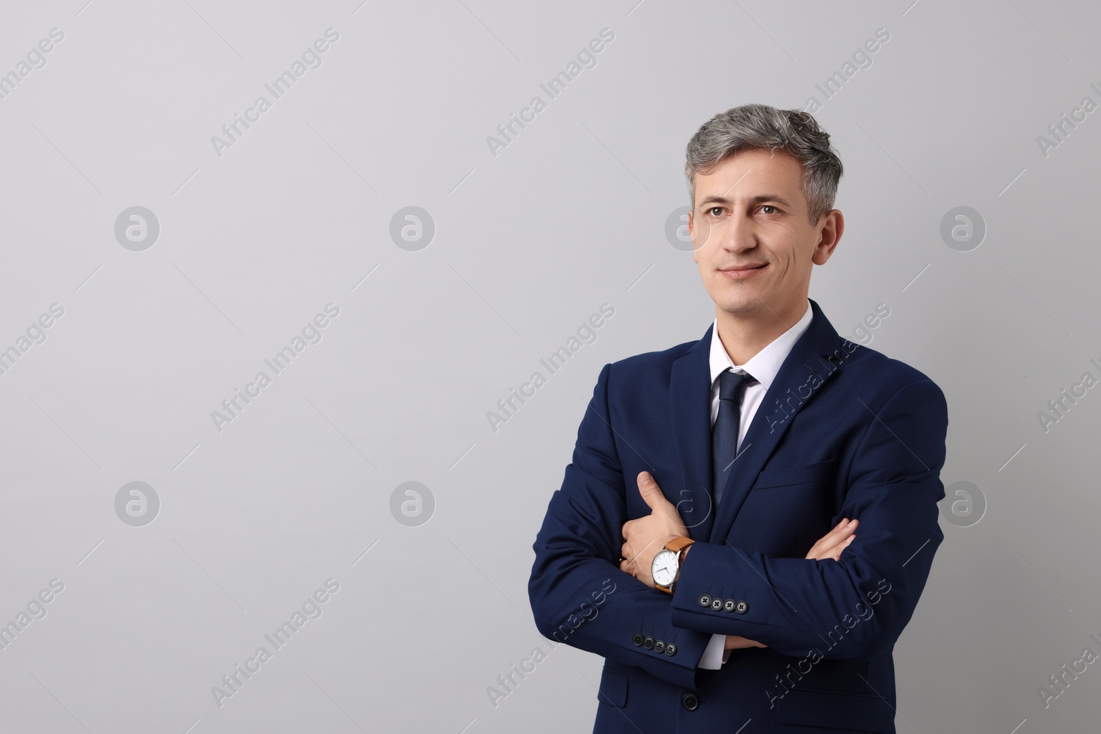 Photo of Portrait of businessman on light grey background, space for text