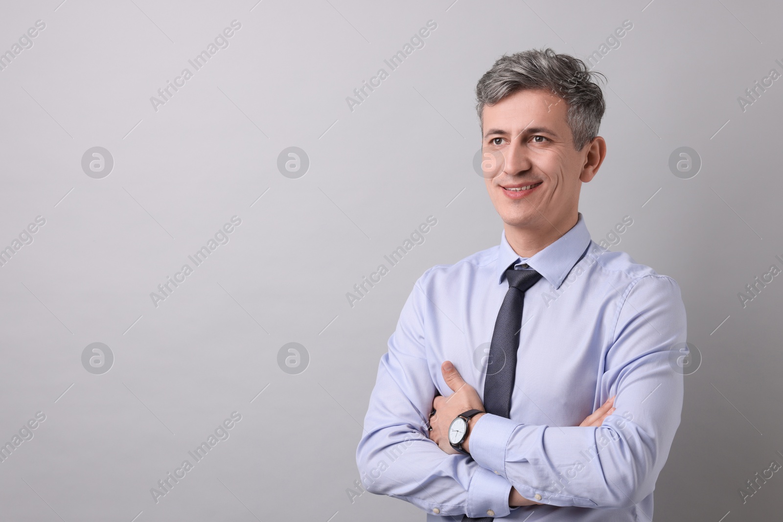 Photo of Portrait of businessman on light grey background, space for text