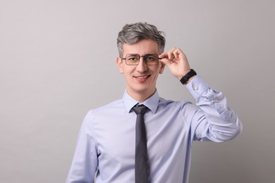 Photo of Portrait of businessman in glasses on light grey background