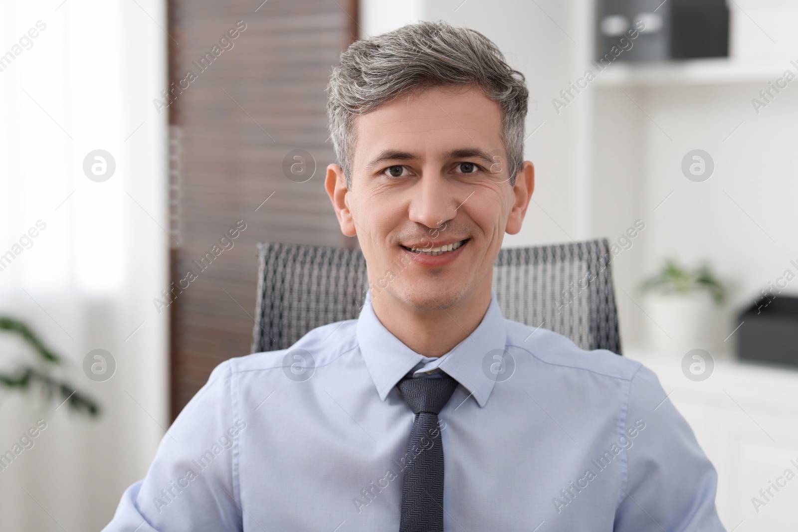 Photo of Portrait of businessman in shirt at workplace