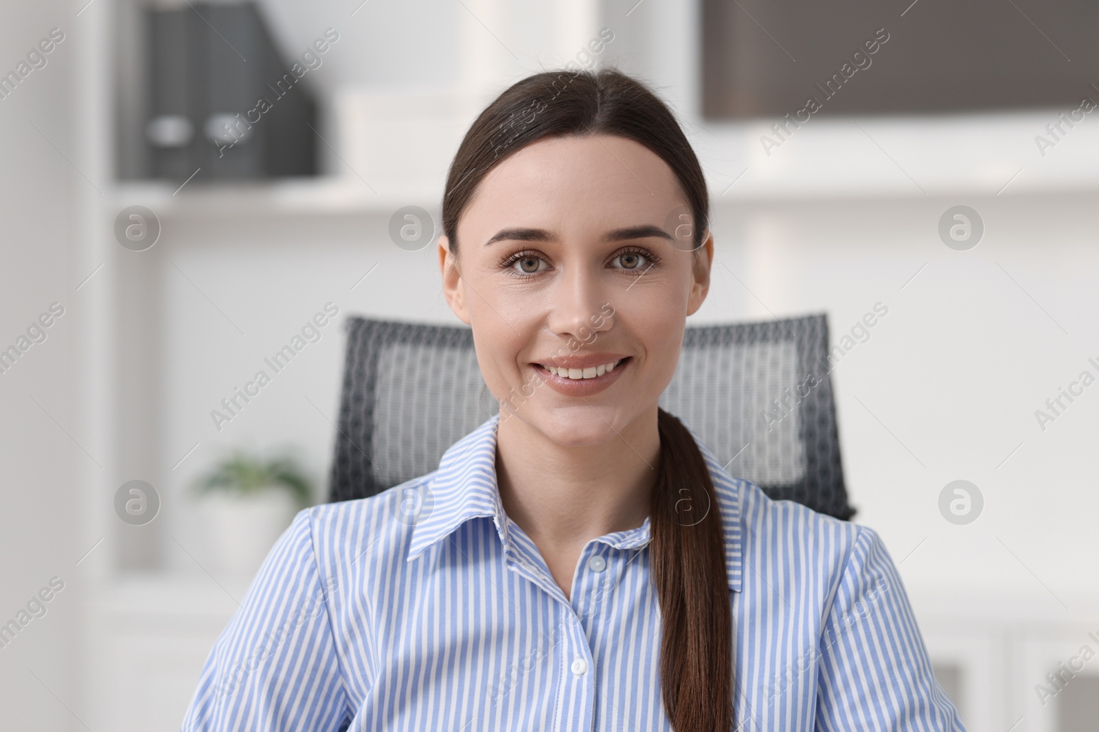 Photo of Portrait of businesswoman in shirt at workplace