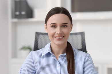 Portrait of businesswoman in shirt at workplace