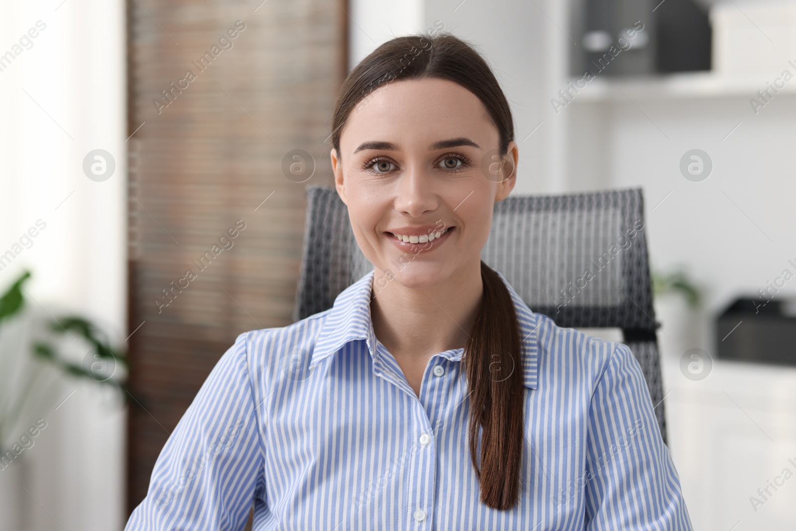 Photo of Portrait of businesswoman in shirt at workplace