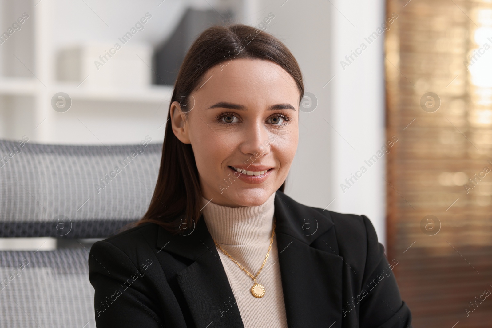 Photo of Portrait of businesswoman in jacket at workplace