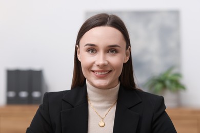 Photo of Portrait of businesswoman in jacket at workplace