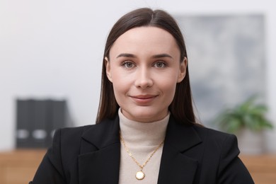 Photo of Portrait of businesswoman in jacket at workplace