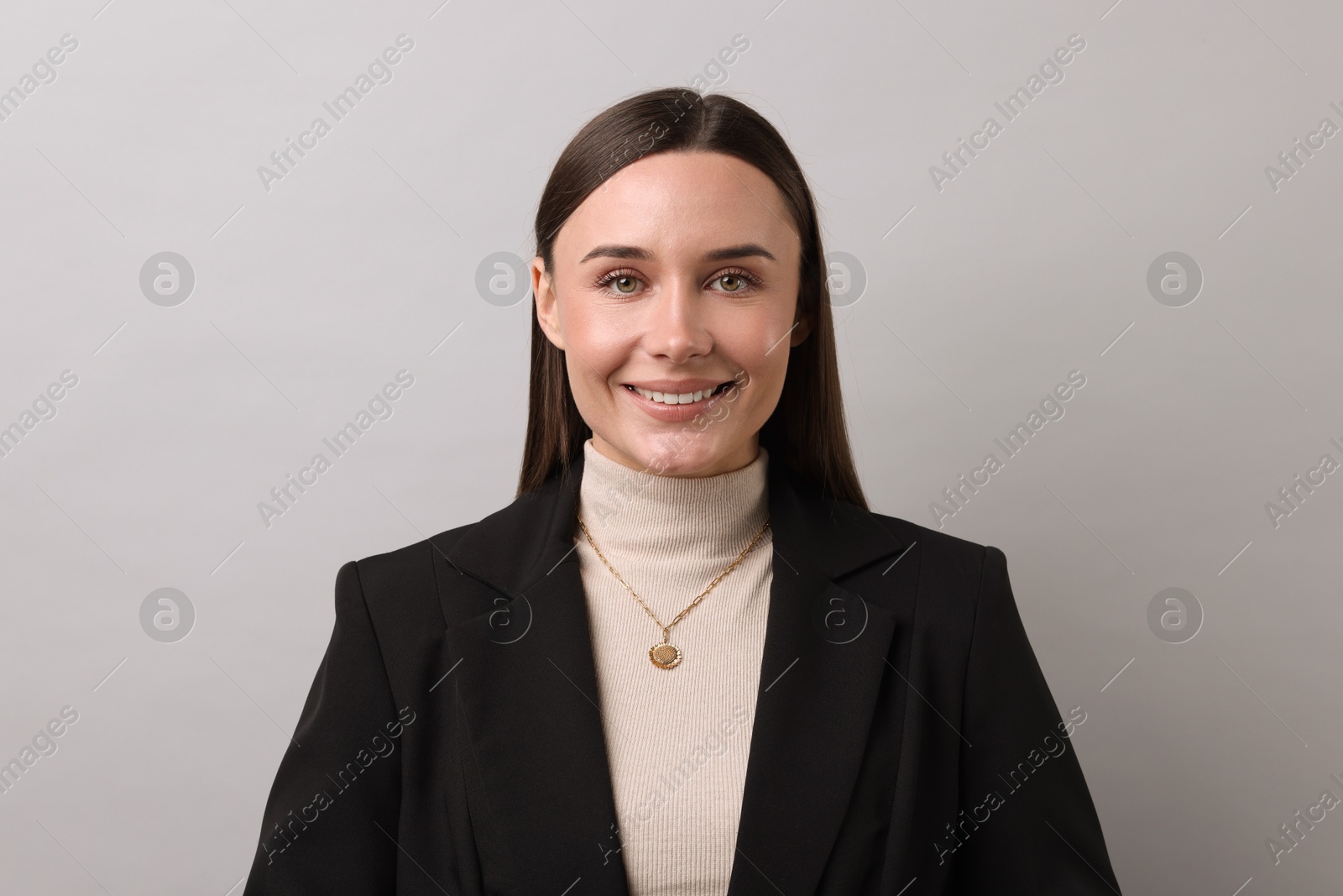 Photo of Portrait of businesswoman on light grey background