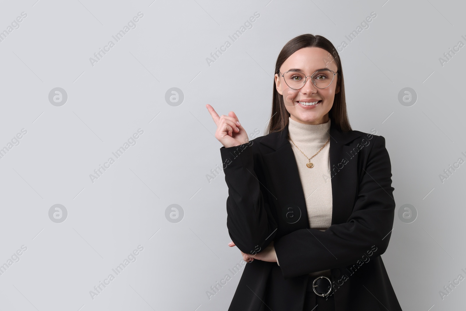 Photo of Portrait of businesswoman in glasses on light grey background, space for text