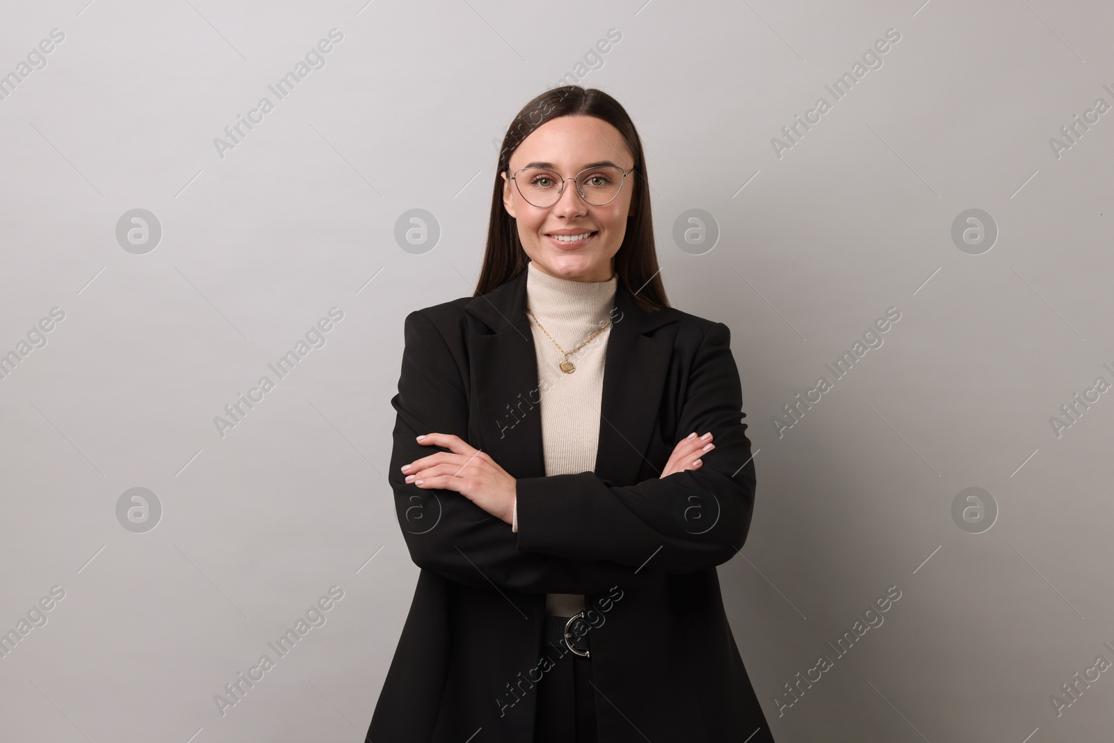 Photo of Portrait of businesswoman in glasses on light grey background