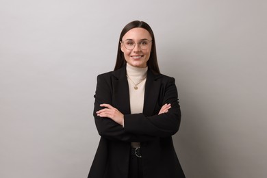 Photo of Portrait of businesswoman in glasses on light grey background