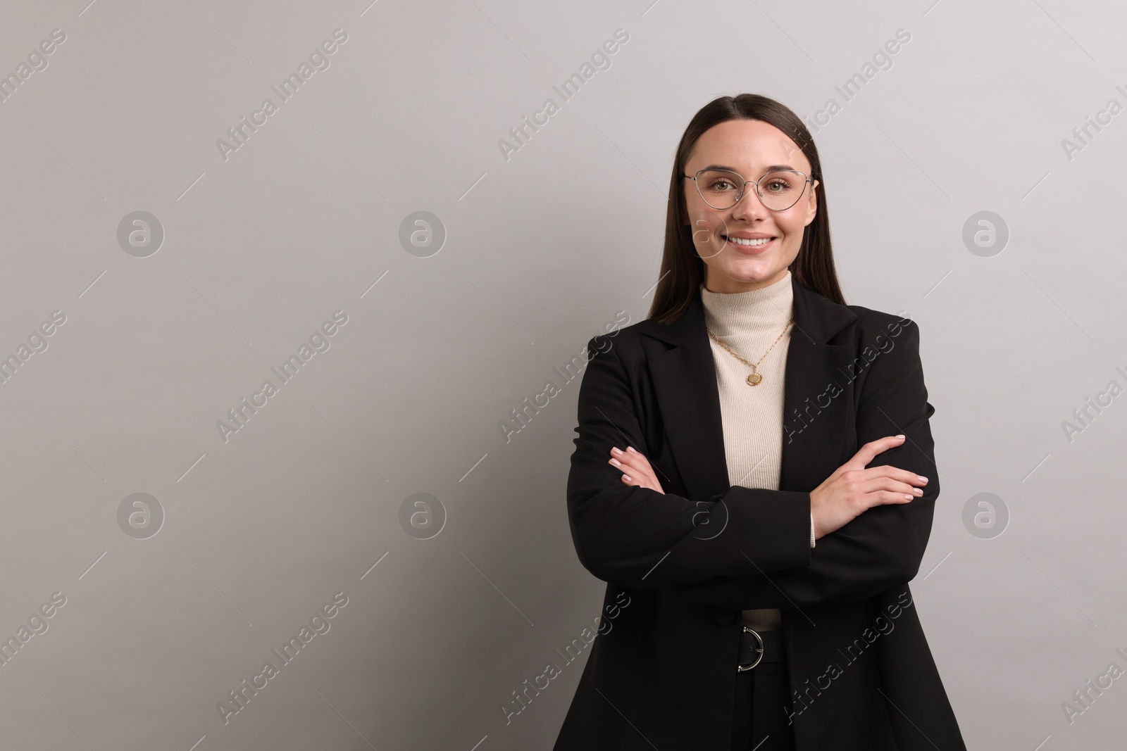 Photo of Portrait of businesswoman in glasses on light grey background, space for text