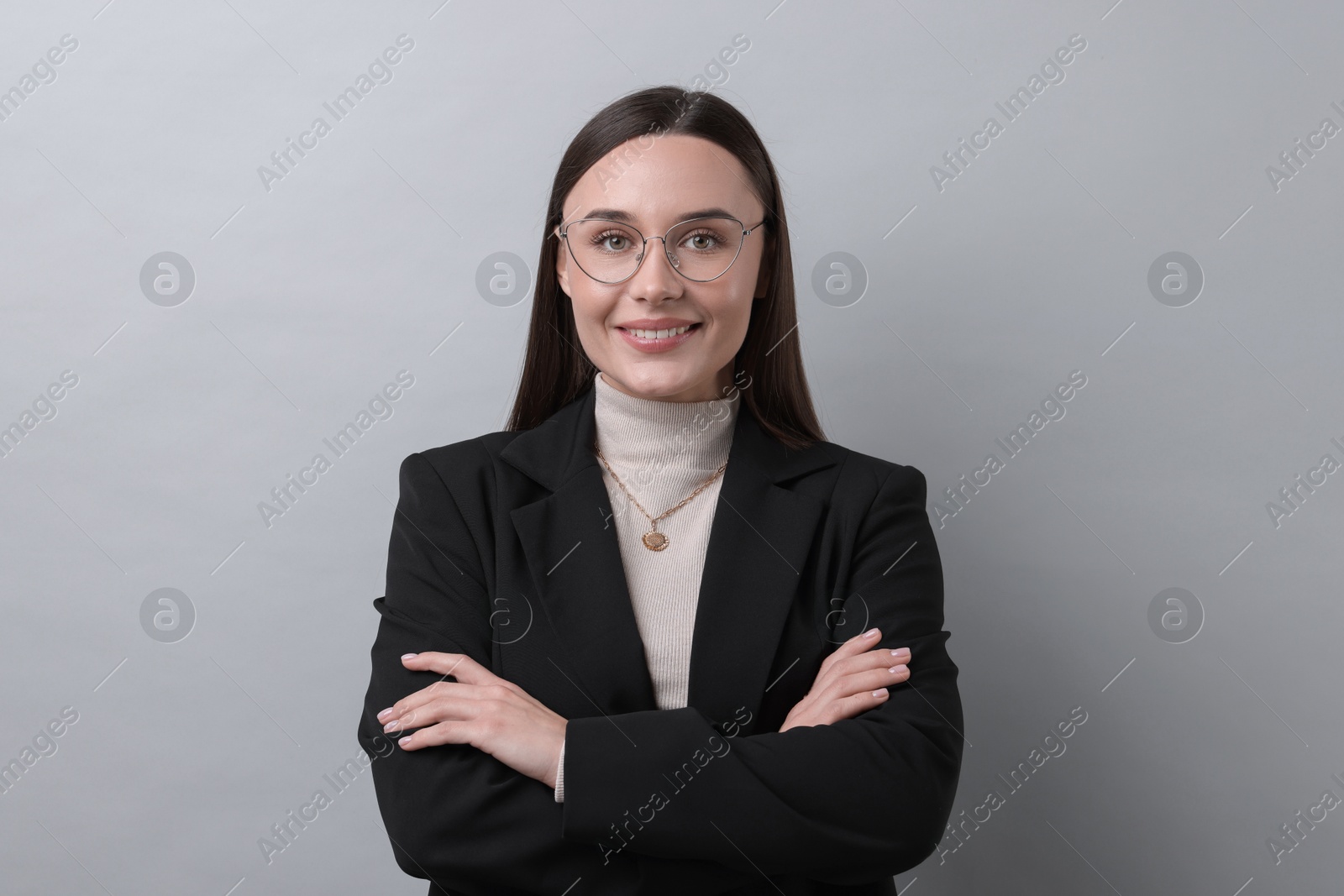 Photo of Portrait of businesswoman in glasses on light grey background