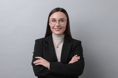 Photo of Portrait of businesswoman in glasses on light grey background