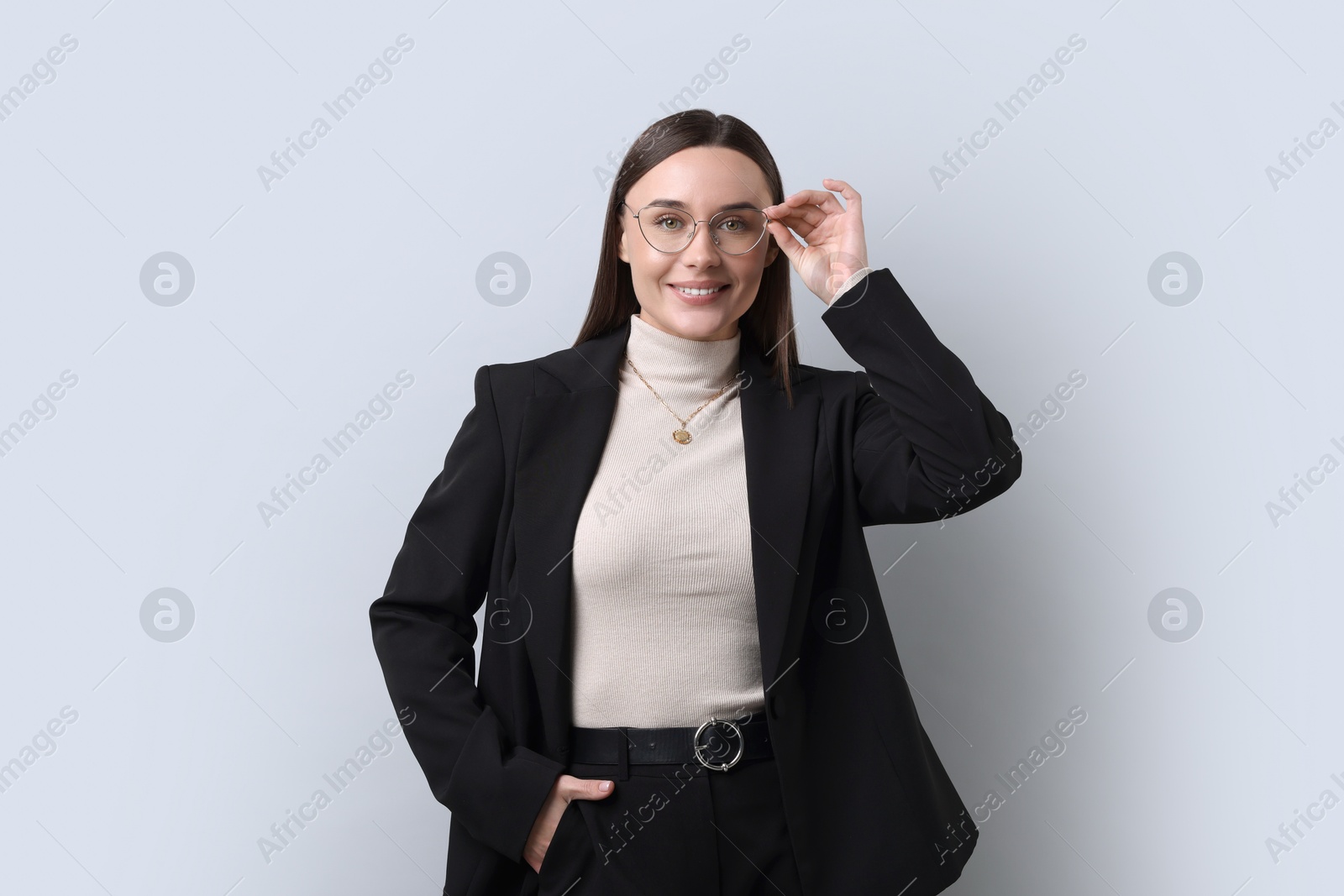 Photo of Portrait of businesswoman in glasses on light grey background