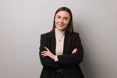 Photo of Portrait of businesswoman on light grey background