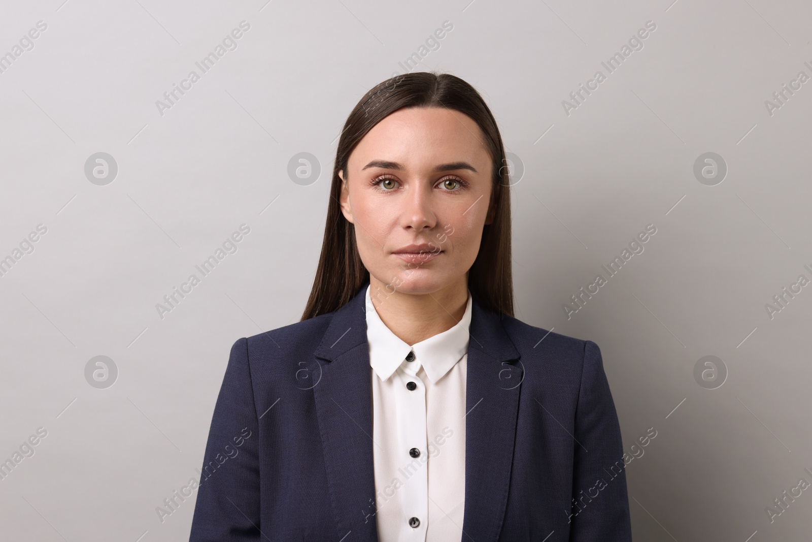 Photo of Portrait of businesswoman on light grey background